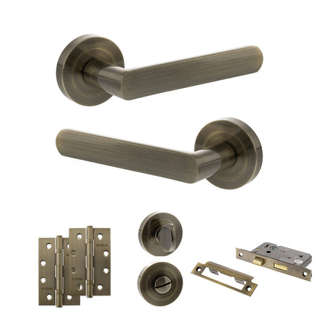 Quality image of STATUS Carolina Door Handle Pack (Bathroom Set - 2.5" CE Bathroom Lock, 4" Slim Knuckle Hinges x2) - Antique Brass | Sku. adps42rab12 | available from Trade Door Handles.
