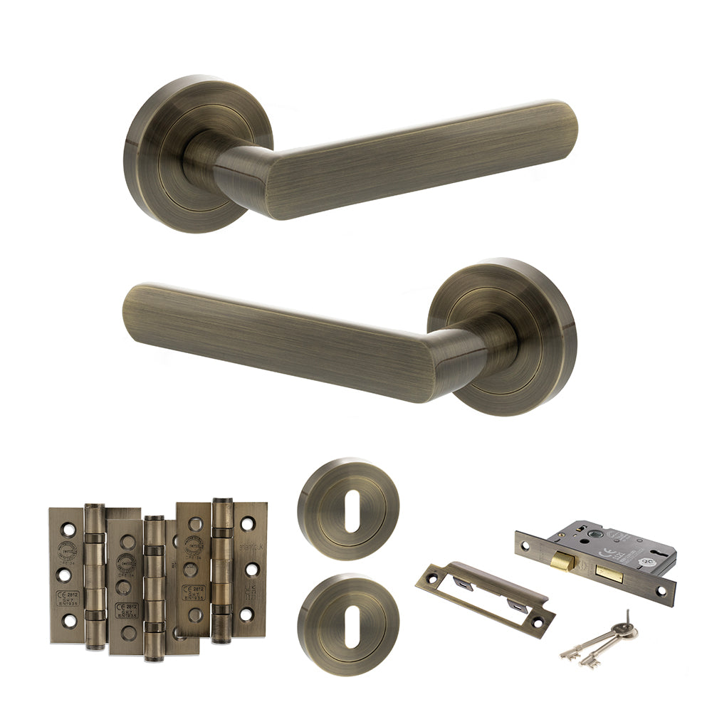Quality image of STATUS Carolina Door Handle Pack (3 Lever Lock Set - 2.5" CE Sashlock, 3" Fire Rated Hinges x3) - Antique Brass | Sku. adps42rab14 | available from Trade Door Handles.