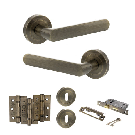 Quality image of STATUS Carolina Door Handle Pack (3 Lever Lock Set - 2.5" CE Sashlock, 3" Fire Rated Hinges x3) - Antique Brass | Sku. adps42rab14 | available from Trade Door Handles.
