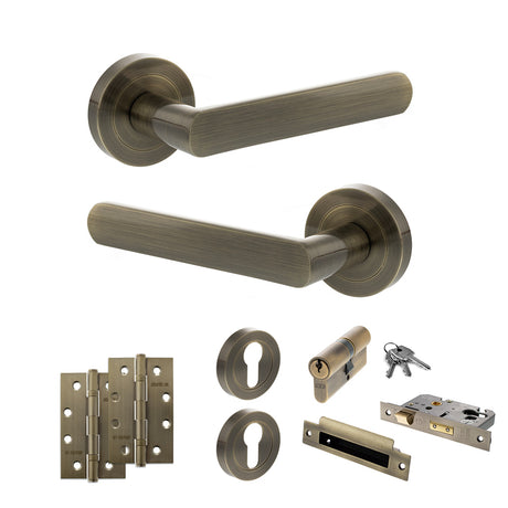 Quality image of STATUS Carolina Door Handle Pack (Euro Lock Set - 2.5" CE Sashlock, 4" Slim Knuckle Hinges x2) - Antique Brass | Sku. adps42rab24 | available from Trade Door Handles.