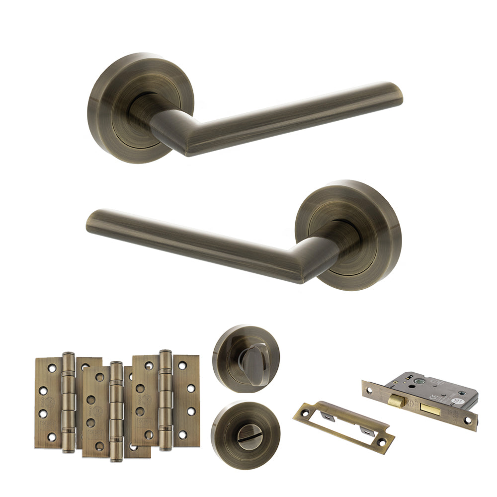 Quality image of STATUS Alabama Door Handle Pack (Bathroom Set - 3" CE Bathroom Lock, 4" Fire Rated Hinges x3) - Antique Brass | Sku. adps43rab11 | available from Trade Door Handles.