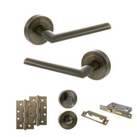 Quality image of STATUS Alabama Door Handle Pack (Bathroom Set - 2.5" CE Bathroom Lock, 4" Slim Knuckle Hinges x2) - Antique Brass | Sku. adps43rab12 | available from Trade Door Handles.