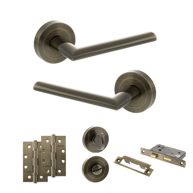 Quality image of STATUS Alabama Door Handle Pack (Bathroom Set - 3" CE Bathroom Lock, 4" Slim Knuckle Hinges x2) - Antique Brass | Sku. adps43rab13 | available from Trade Door Handles.