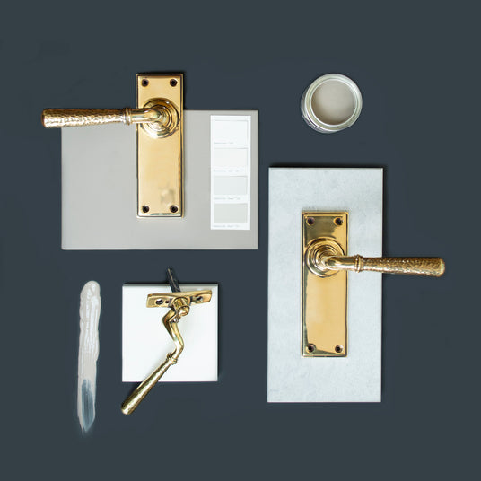 Image showing a collection of door handles and window furniture in Aged Brass by From The Anvil, available to order from Trade Door Handles in Kendal