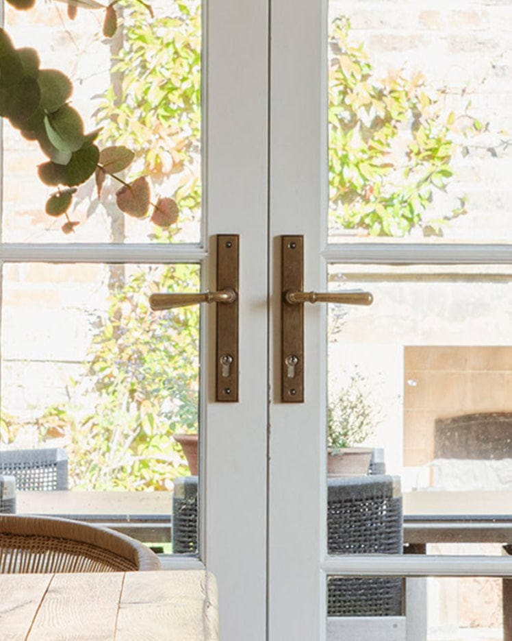 This is a image of From The Anvil Aged Brass Newbury Slimline Lever Espag. Lock Set Handles