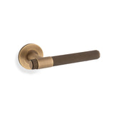 High quality image of Alexander & Wilks - Knurled Kingstone Lever on Round Rose - Antique Brass | Sku. aw240ab | Trade Door Handles.