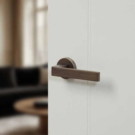 Quality image of Forme Asti Lever Door Handle on Minimal Round Rose - Urban Bronze | Sku. fmr254ub | available from Trade Door Handles.