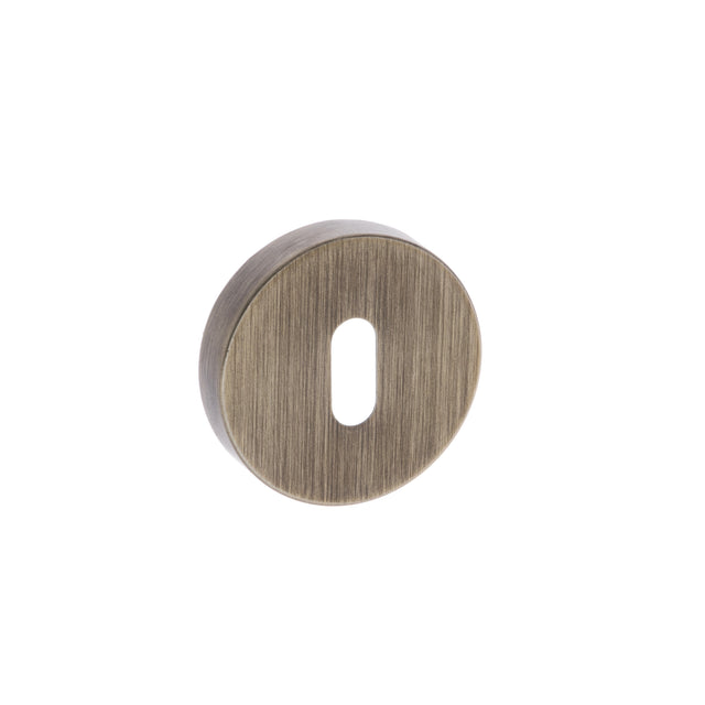 Quality image of Forme Key Escutcheons on Minimal Round Rose - Yester Bronze | Sku. fmrkyb | available from Trade Door Handles.