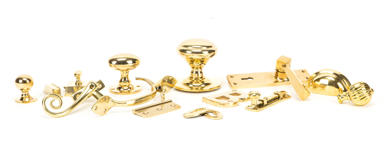 Image showing a range of From The Anvil Ironmongery and Hardware in Polished Brass.  Available to order from Trade Door Handles in Kendal