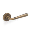 High quality image of Valli Teseo Lever on Round Rosette - Antique Brass| Sku. H1037AB |Trade Door Handles.