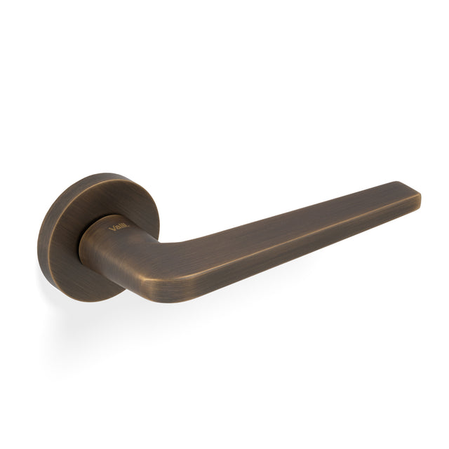 High quality image of Valli David Chipperfield Lever on Round Rosette - Antique Brass| Sku. H348AB |Trade Door Handles.