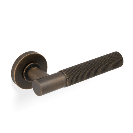 High quality image of Valli Antonio Citterio Lever on Round Rosette (Zigrinato) - Antique Brass| Sku. H379AB |Trade Door Handles.