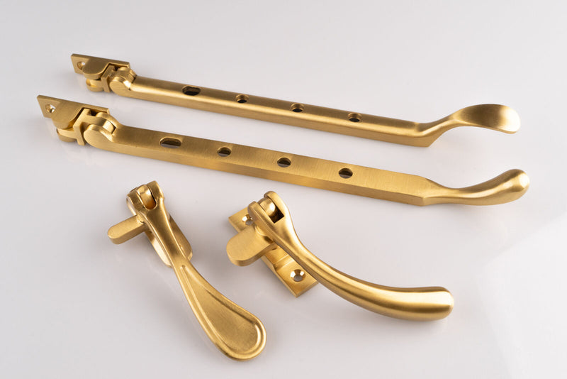 Image show Carlisle Brass Casement window stays and fasteners in a satin brass finish
