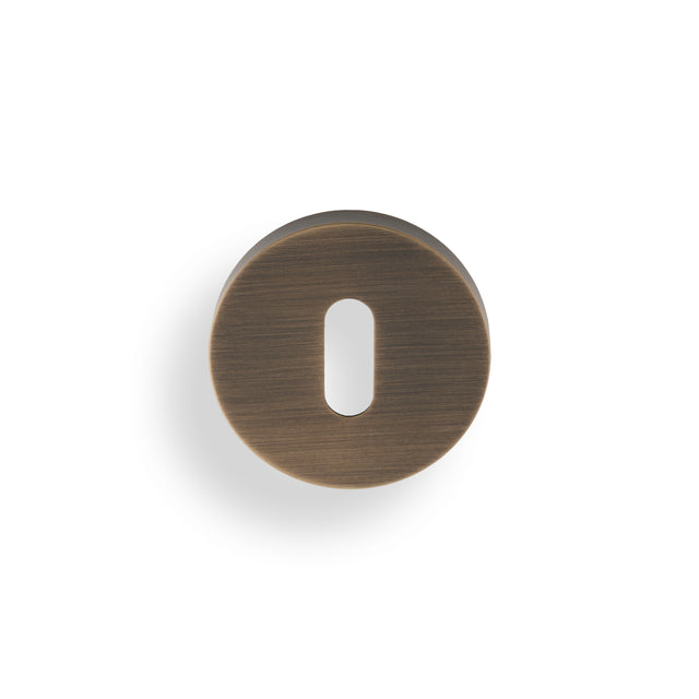 High quality image of Valli Lock Profile Push-on Round Rosette Escutcheon - Antique Brass| Sku. K1103AB |Trade Door Handles.