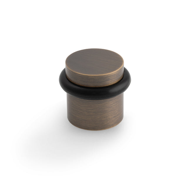 High quality image of Valli 38 x 35mm - Floor Mounted Plain Doorstop - Concealed Fix - Antique Brass| Sku. K1300AB |Trade Door Handles.