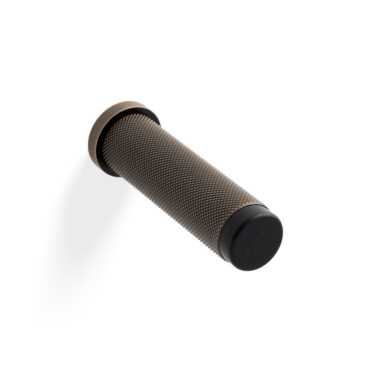 High quality image of Valli 76 x 20mm - Wall Mounted Knurled Doorstop on Rose - Concealed Fix - Antique Brass| Sku. K1401AB |Trade Door Handles.