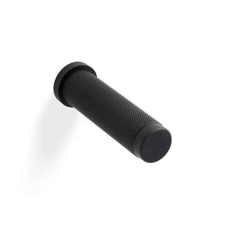 High quality image of Valli 76 x 20mm - Wall Mounted Knurled Doorstop on Rose - Concealed Fix - Matt Black PVD| Sku. K1401MBPVD |Trade Door Handles.