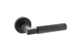 Quality image of Millhouse Brass Cartwright Knurled Lever Door Handle on Round Rose - Matt Black | Sku. mhr200mb | available from Trade Door Handles.