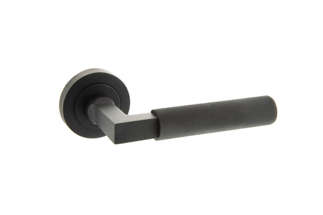 Quality image of Millhouse Brass Cartwright Knurled Lever Door Handle on Round Rose - Matt Black | Sku. mhr200mb | available from Trade Door Handles.