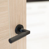Quality image of Millhouse Brass Cartwright Knurled Lever Door Handle on Round Rose - Matt Black | Sku. mhr200mb | available from Trade Door Handles.