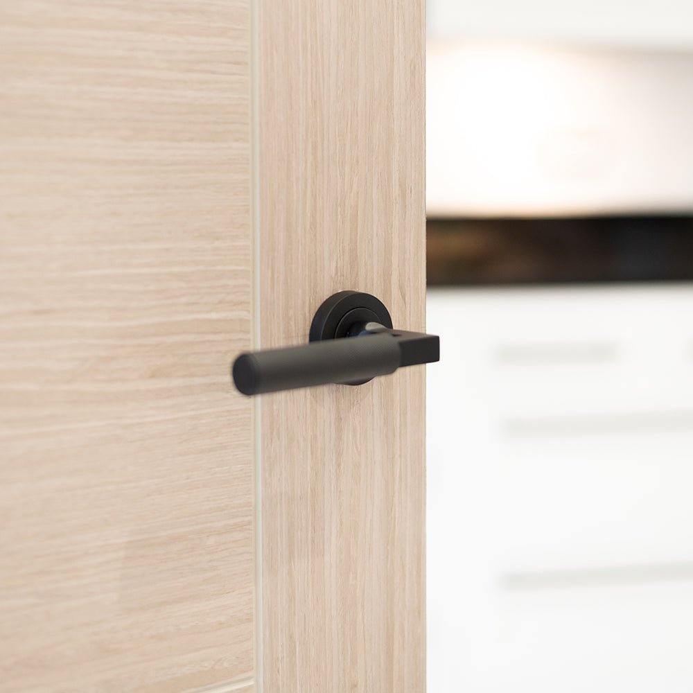 Quality image of Millhouse Brass Cartwright Knurled Lever Door Handle on Round Rose - Matt Black | Sku. mhr200mb | available from Trade Door Handles.