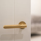 Quality image of Millhouse Brass Crompton Knurled Lever Door Handle on 5mm Slimline Round Rose - Satin Brass | Sku. mhsr100sb | available from Trade Door Handles.