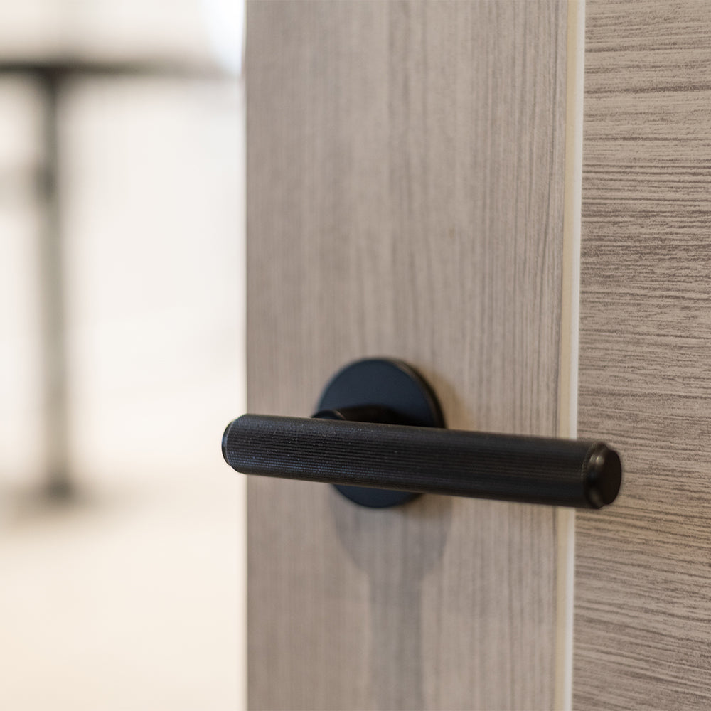 Quality image of Millhouse Brass Stephenson Knurled Lever Door Handle on 5mm Slimline Round Rose - Matt Black | Sku. mhsr250mb | available from Trade Door Handles.