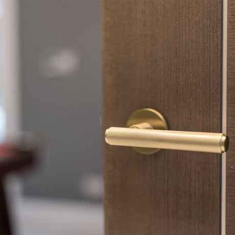 Quality image of Millhouse Brass Stephenson Knurled Lever Door Handle on 5mm Slimline Round Rose - Satin Brass | Sku. mhsr250sb | available from Trade Door Handles.