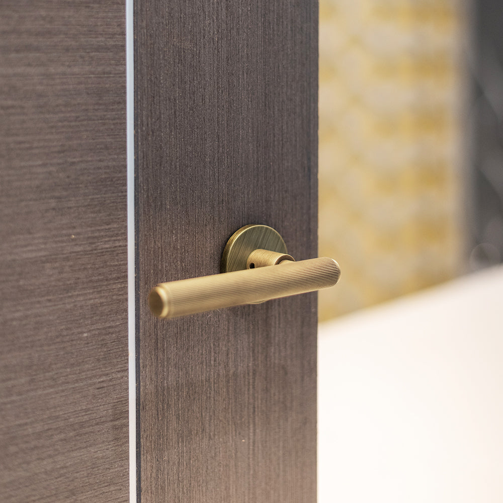 Quality image of Millhouse Brass Stephenson Knurled Lever Door Handle on 5mm Slimline Round Rose - Yester Bronze | Sku. mhsr250yb | available from Trade Door Handles.