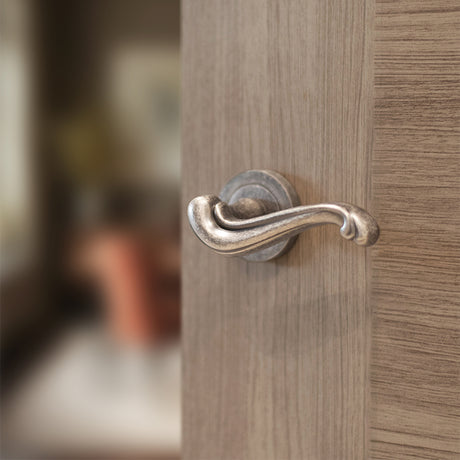 Quality image of Old English Colchester Lever Door Handle on Round Rose - Distressed Silver | Sku. oe177ds | available from Trade Door Handles.