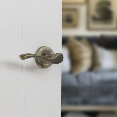 Quality image of Old English Warwick Lever Door Handle on Round Rose - Matt Antique Brass | Sku. oe178mab | available from Trade Door Handles.