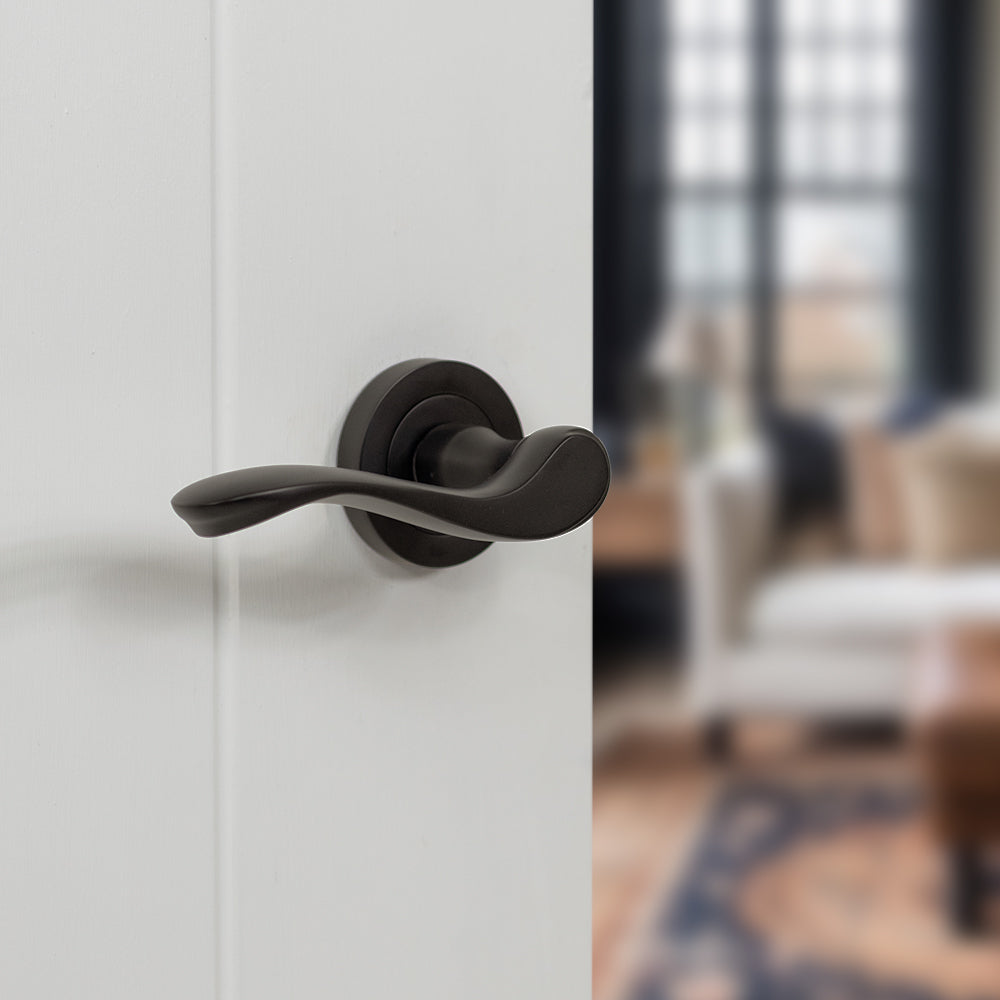 Quality image of Old English Warwick Lever Door Handle on Round Rose - Urban Dark Bronze | Sku. oe178udb | available from Trade Door Handles.