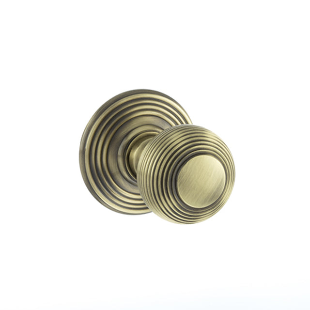 Quality image of Old English Ripon Solid Brass Reeded Mortice Knob on Concealed Fix Rose - Antique Brass | Sku. oe50rmkab | available from Trade Door Handles.