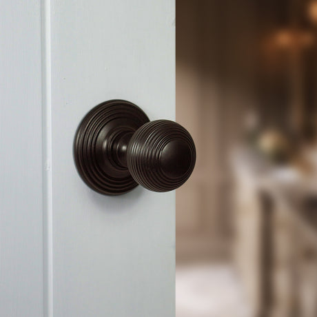 Quality image of Old English Ripon Solid Brass Reeded Mortice Knob on Concealed Fix Rose - Urban Dark Bronze | Sku. oe50rmkudb | available from Trade Door Handles.