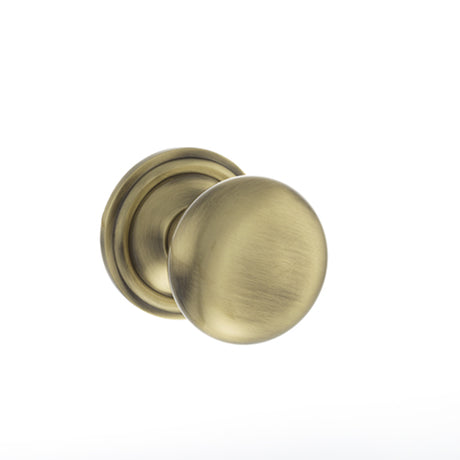 Quality image of Old English Harrogate Solid Brass Mushroom Mortice Knob on Concealed Fix Rose - Antique Brass | Sku. oe58mmkab | available from Trade Door Handles.