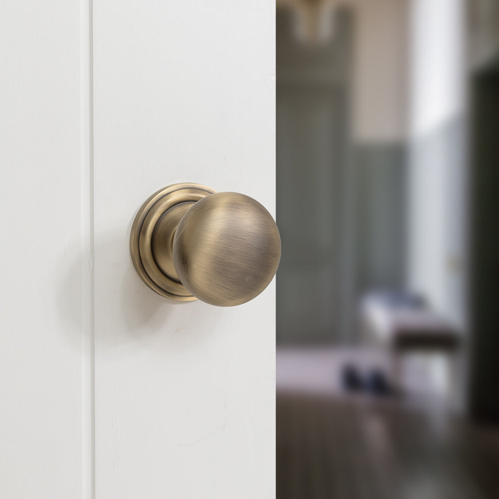 Quality image of Old English Harrogate Solid Brass Mushroom Mortice Knob on Concealed Fix Rose - Matt Antique Brass | Sku. oe58mmkmab | available from Trade Door Handles.