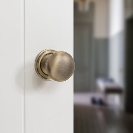 Quality image of Old English Harrogate Solid Brass Mushroom Mortice Knob on Concealed Fix Rose - Matt Antique Brass | Sku. oe58mmkmab | available from Trade Door Handles.