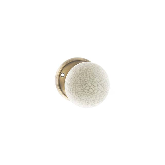 Quality image of Old English Skipton Porcelain Cream Crackle Door Knob on Face Fix Rose - Antique Brass | Sku. oe59cmkcab | available from Trade Door Handles.