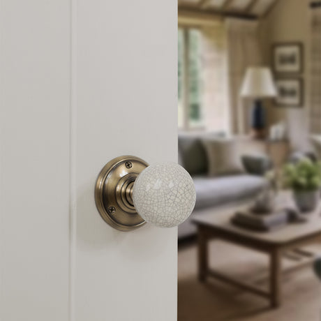 Quality image of Old English Skipton Porcelain Cream Crackle Door Knob on Face Fix Rose - Antique Brass | Sku. oe59cmkcab | available from Trade Door Handles.