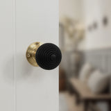 Quality image of Old English Whitby Ebony Wood Reeded Beehive Mortice Knob on Face Fix Rose - Polished Brass | Sku. oe60rremkpb | available from Trade Door Handles.