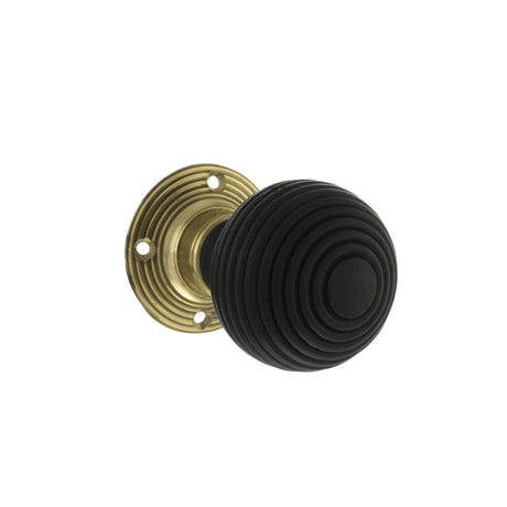 Quality image of Old English Whitby Ebony Wood Reeded Beehive Mortice Knob on Face Fix Rose - Polished Brass | Sku. oe60rremkpb | available from Trade Door Handles.