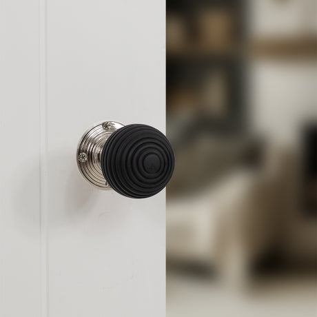 Quality image of Old English Whitby Ebony Wood Reeded Beehive Mortice Knob on Face Fix Rose - Polished Nickel | Sku. oe60rremkpn | available from Trade Door Handles.