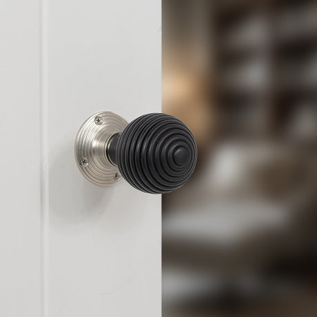 Quality image of Old English Whitby Ebony Wood Reeded Beehive Mortice Knob on Face Fix Rose - Satin Nickel | Sku. oe60rremksn | available from Trade Door Handles.