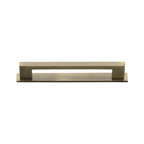 High quality image of the Heritage Brass Cabinet Pull Metro Design with Plate 96mm CTC Antique Brass Finish | Sku. pl0337-96-at | Discounted prices available from Trade Door Handles