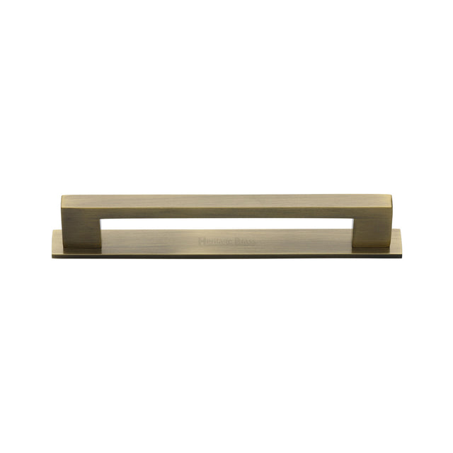 High quality image of the Heritage Brass Cabinet Pull Metro Design with Plate 96mm CTC Antique Brass Finish | Sku. pl0337-96-at | Discounted prices available from Trade Door Handles