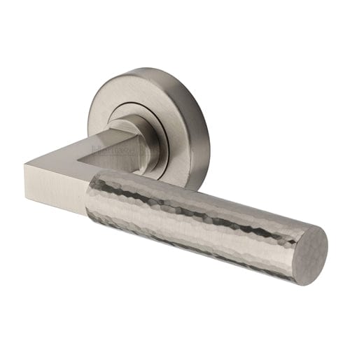 This is an image of the Heriateg Brass Hammered Bauhaus Door Handle on Round Rose ham2259 sn