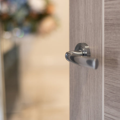 Quality image of STATUS Nevada Lever Door Handle on Round Rose - Polished Chrome | Sku. s21rpc | available from Trade Door Handles.