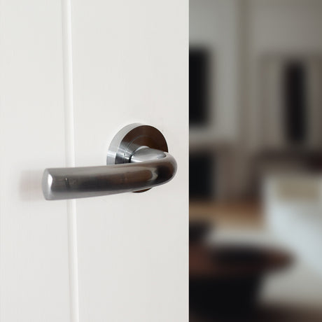 Quality image of STATUS Nevada Lever Door Handle on Round Rose - Satin Chrome | Sku. s21rsc | available from Trade Door Handles.