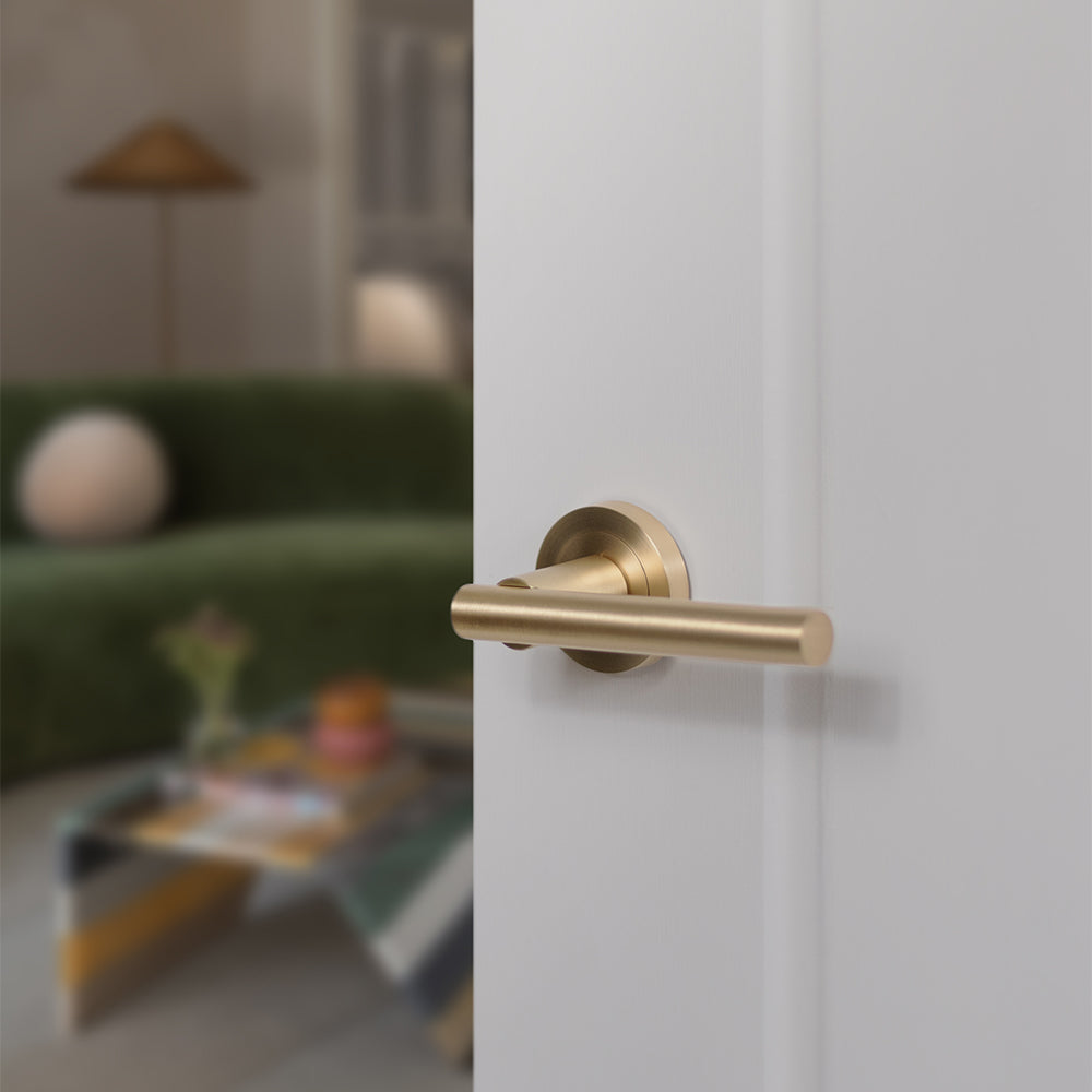 Quality image of STATUS Nebraska Lever Door Handle on Round Rose - Satin Brass | Sku. s28rsb | available from Trade Door Handles.