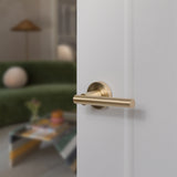 Quality image of STATUS Nebraska Lever Door Handle on Round Rose - Satin Brass | Sku. s28rsb | available from Trade Door Handles.